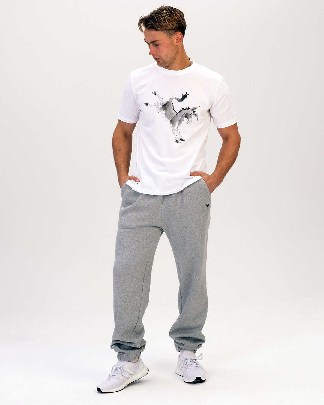 Man wearing a Rolf Skeldon t-shirt and grey sweatpants