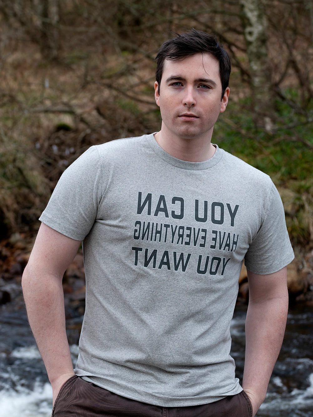 Man wearing a recycled cotton grey t-shirt with motivational text