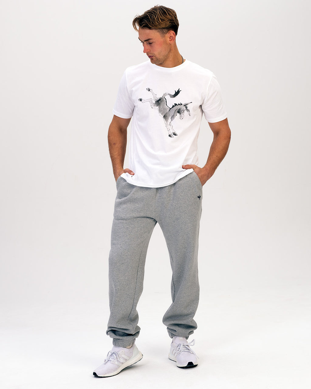 Man wearing a Rolf Skeldon t-shirt and grey sweatpants